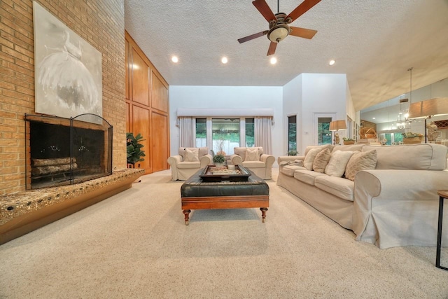 carpeted living room with a fireplace, a textured ceiling, and ceiling fan