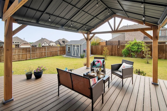 wooden deck with a lawn, a storage shed, a gazebo, and outdoor lounge area