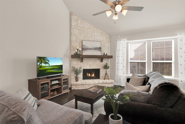 living room featuring wood-type flooring, a stone fireplace, high vaulted ceiling, and ceiling fan