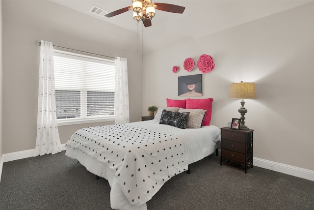 bedroom with lofted ceiling, ceiling fan, and dark carpet