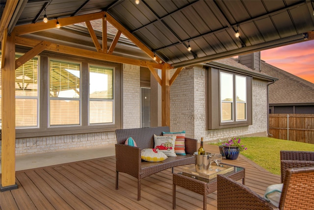 sunroom / solarium with vaulted ceiling and track lighting