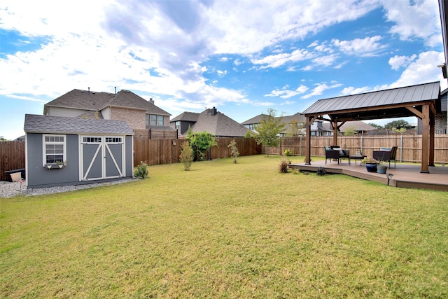 view of yard with a gazebo, a storage shed, and a patio area