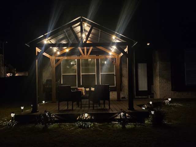 back house at twilight featuring a wooden deck