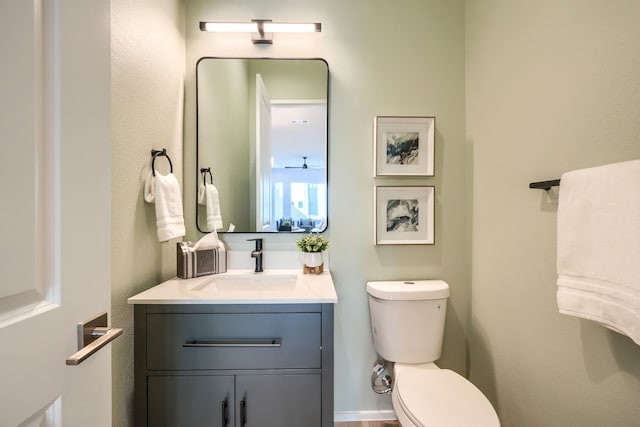 bathroom with vanity, ceiling fan, and toilet