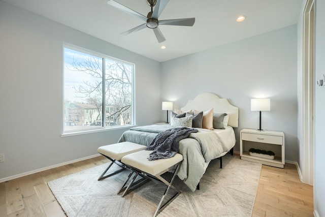 bedroom with ceiling fan and light hardwood / wood-style flooring