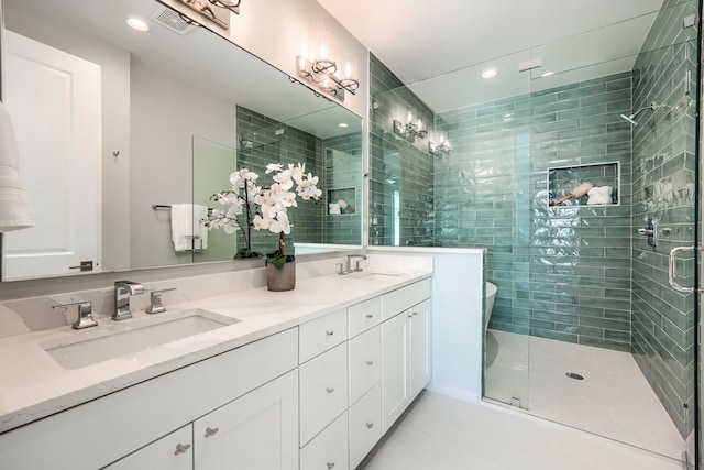 bathroom featuring vanity, tile patterned floors, and a shower with shower door