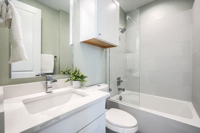 full bathroom with tiled shower / bath combo, toilet, and vanity