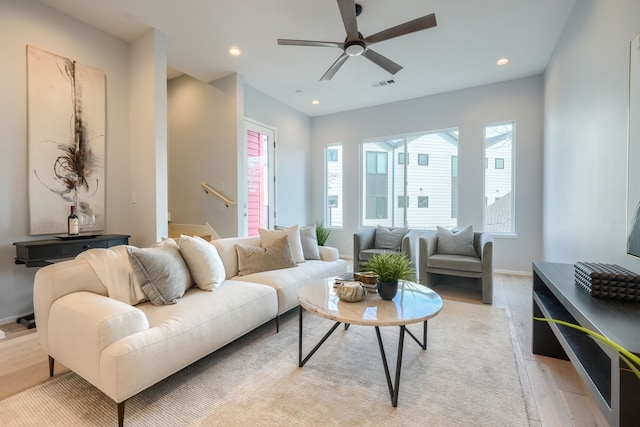 living room with ceiling fan and light hardwood / wood-style floors