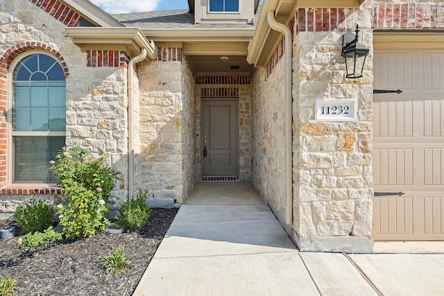 view of exterior entry with a garage