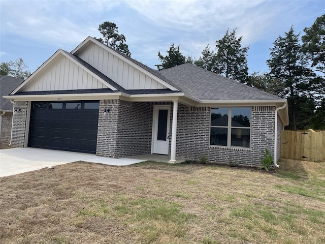 view of front of home featuring a front lawn and a garage