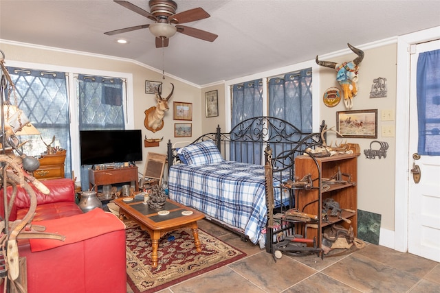 bedroom featuring ornamental molding, ceiling fan, and vaulted ceiling