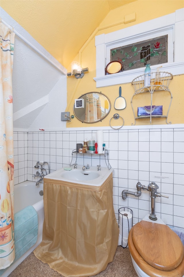 full bathroom featuring toilet, tile walls, and sink