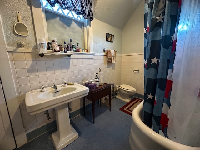 bathroom with a textured ceiling, tile walls, toilet, and shower with separate bathtub