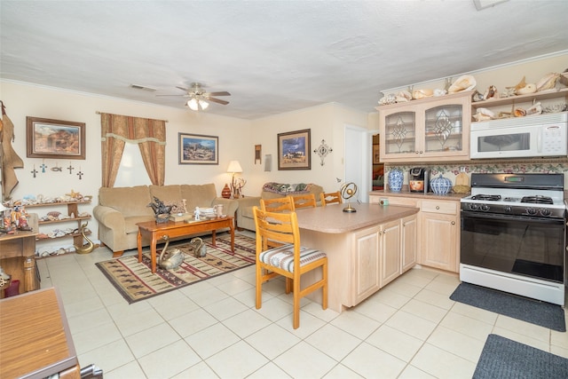 kitchen featuring ceiling fan, white appliances, light brown cabinets, kitchen peninsula, and light tile patterned floors