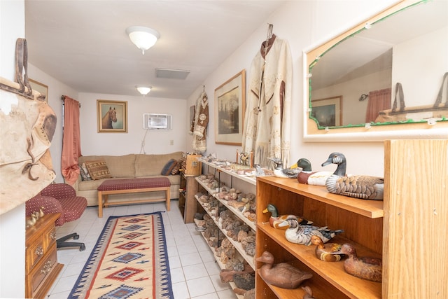 interior space with a wall mounted air conditioner and light tile patterned floors