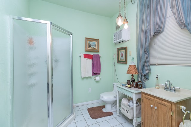 bathroom with toilet, tile patterned floors, an AC wall unit, a shower with door, and vanity