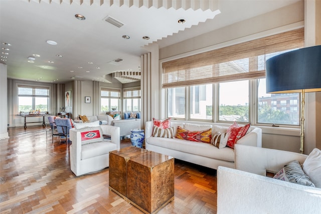 living room featuring parquet floors and a healthy amount of sunlight