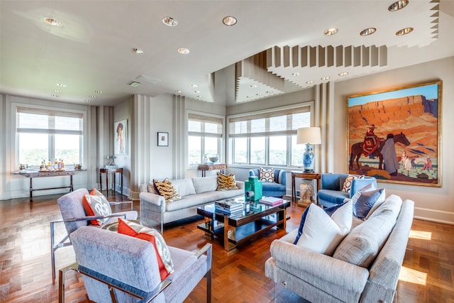 living room featuring parquet flooring and a healthy amount of sunlight