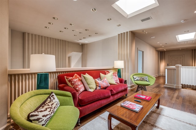 living room with a skylight and hardwood / wood-style floors