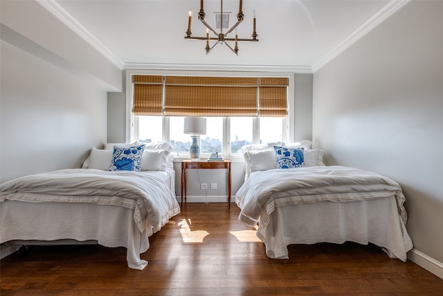 bedroom featuring ornamental molding, hardwood / wood-style flooring, and an inviting chandelier