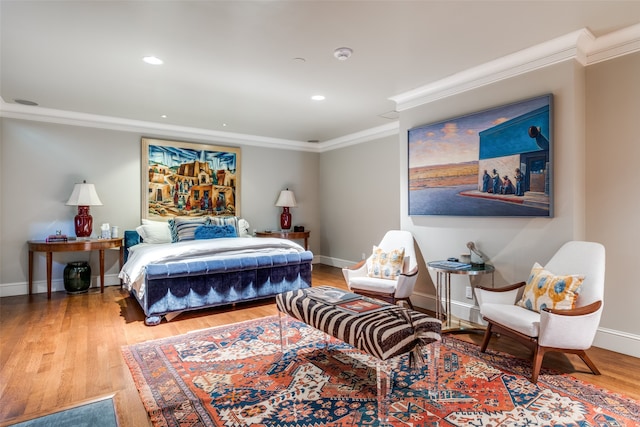 bedroom featuring ornamental molding and hardwood / wood-style floors