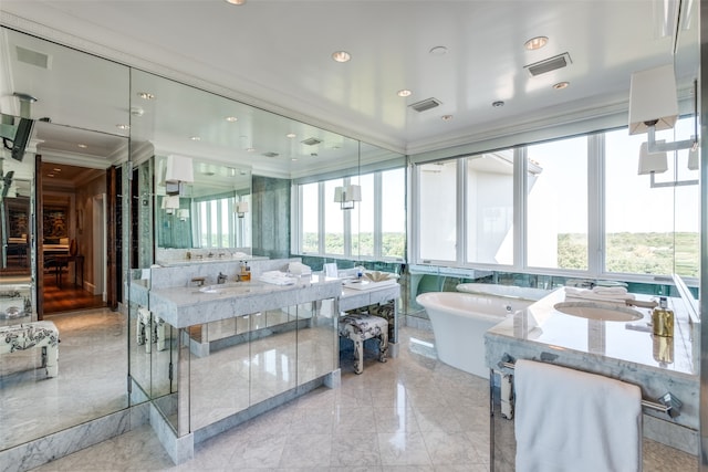 bathroom with a bath, crown molding, vanity, and a wealth of natural light