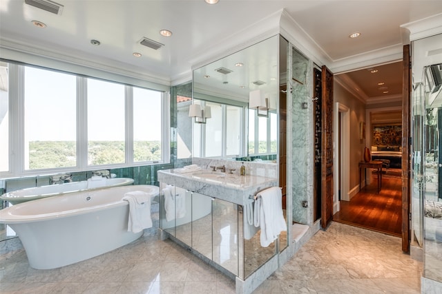 bathroom with ornamental molding, independent shower and bath, vanity, and wood-type flooring