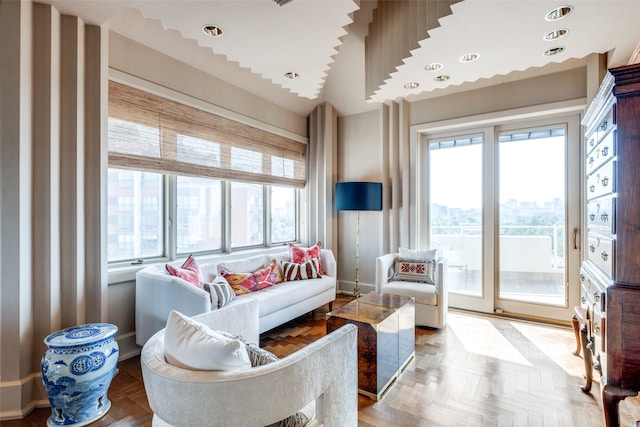 living room featuring lofted ceiling, parquet flooring, and a healthy amount of sunlight