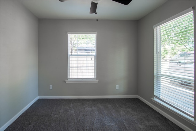 carpeted spare room featuring ceiling fan