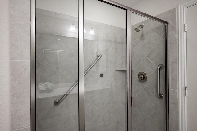 bathroom featuring tile patterned floors, vanity, and a shower with shower door