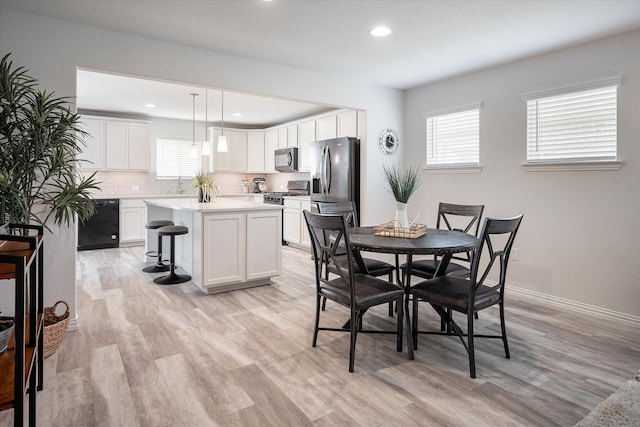 living room featuring light wood-type flooring and ceiling fan