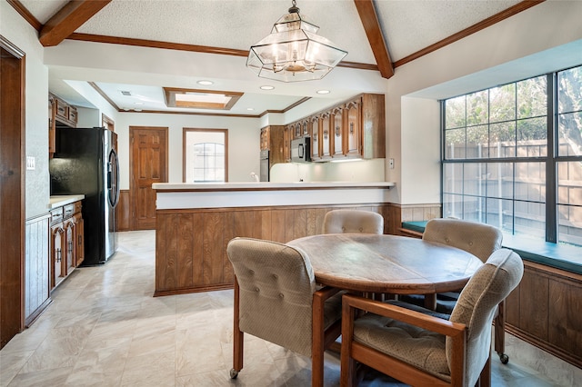 dining room with lofted ceiling with beams, crown molding, an inviting chandelier, and a textured ceiling