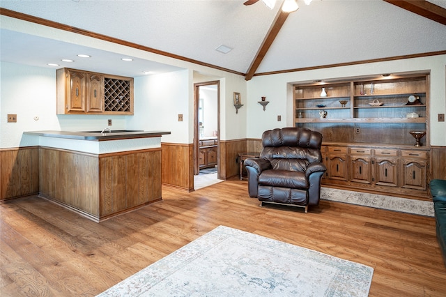 interior space featuring light hardwood / wood-style floors, crown molding, lofted ceiling with beams, and a textured ceiling