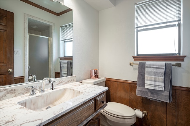 bathroom with walk in shower, vanity, wooden walls, and toilet