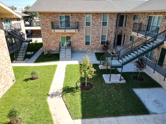 view of home's community with a lawn