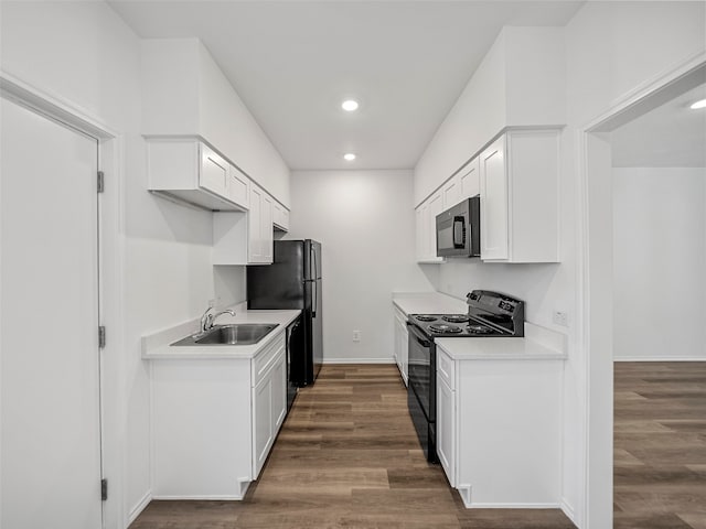 kitchen with sink, black appliances, white cabinets, and dark hardwood / wood-style flooring