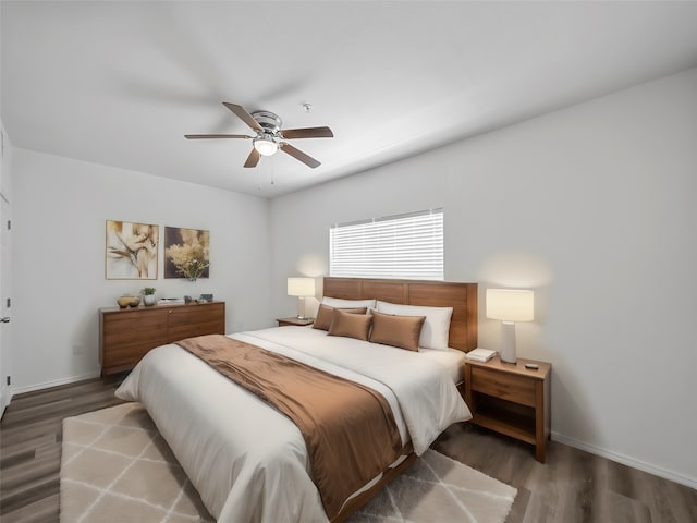 bedroom with dark wood-type flooring and ceiling fan