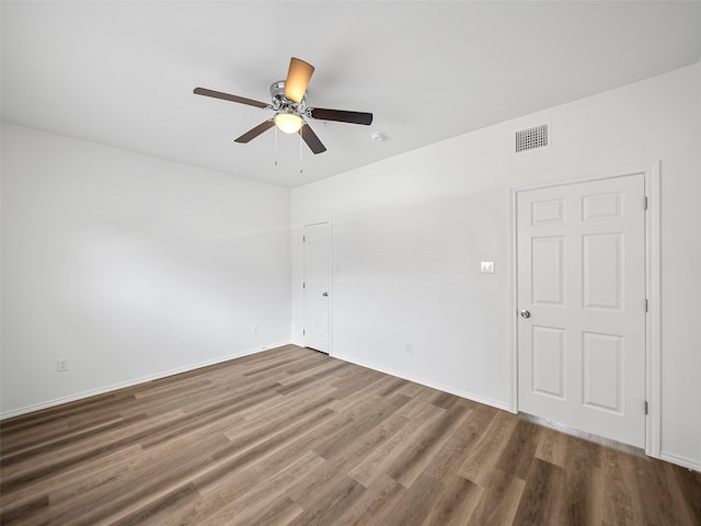 spare room featuring ceiling fan and hardwood / wood-style flooring