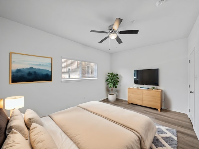 bedroom with ceiling fan and hardwood / wood-style floors