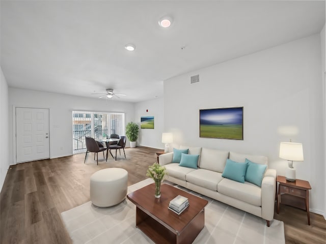 living room featuring ceiling fan and hardwood / wood-style floors