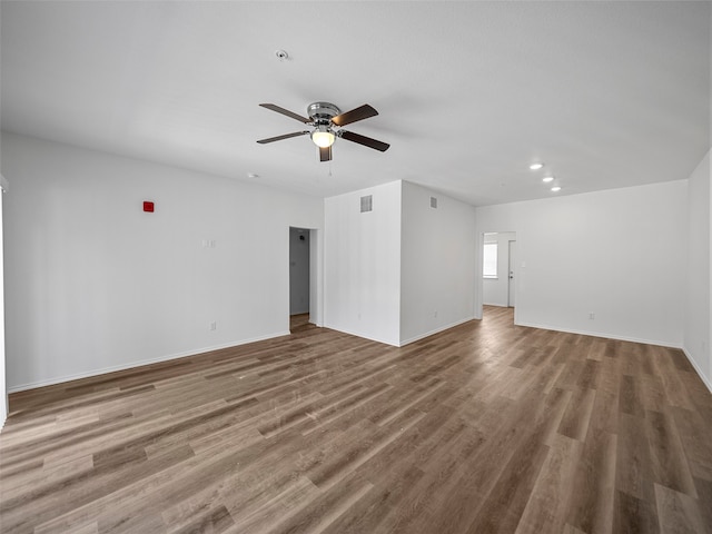 unfurnished living room featuring ceiling fan and wood-type flooring