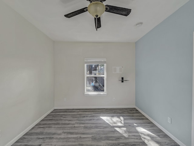 spare room with light wood-type flooring and ceiling fan