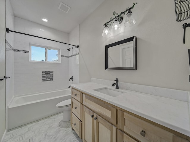 full bathroom featuring toilet, tiled shower / bath combo, and vanity