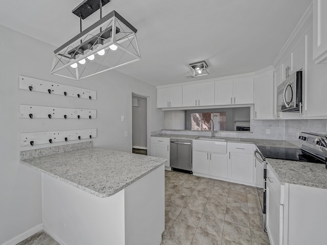 kitchen featuring kitchen peninsula, white cabinets, appliances with stainless steel finishes, pendant lighting, and sink