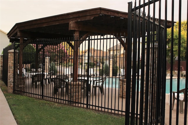 view of gate with a community pool