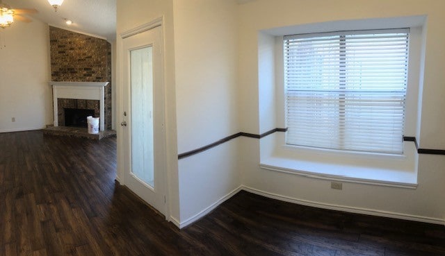 corridor featuring lofted ceiling and dark hardwood / wood-style flooring