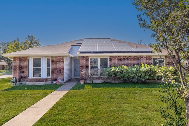 single story home featuring a front yard and solar panels