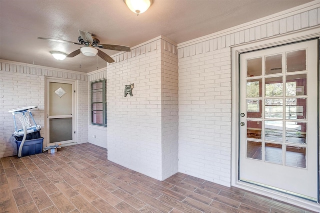 kitchen with sink, white appliances, light tile patterned floors, white cabinetry, and a brick fireplace