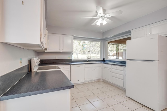 kitchen featuring sink, white appliances, light tile patterned floors, ceiling fan, and white cabinetry