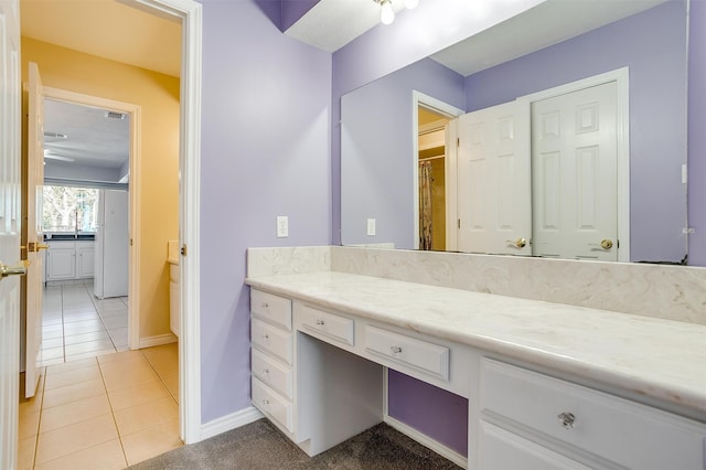 bathroom featuring tile patterned flooring and vanity